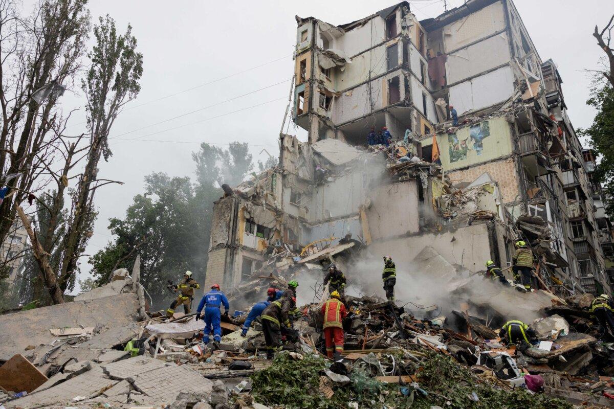 Rescuers clear debris as they work at the site of a destroyed building following a Russian air attack in Kyiv, Ukraine, on July 31, 2025. (Photo by Tetiana Dzhafarova/AFP via Getty Images)