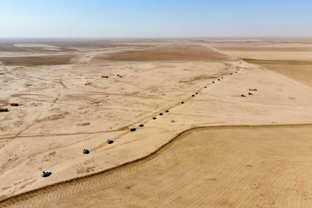 Iraqi forces, supported by members of the Hashed al-Shaabi, advance in the al-Hadar desert during a security operation on Aug. 5, 2025. (Zaid Al-Obeidi/AFP via Getty Images)