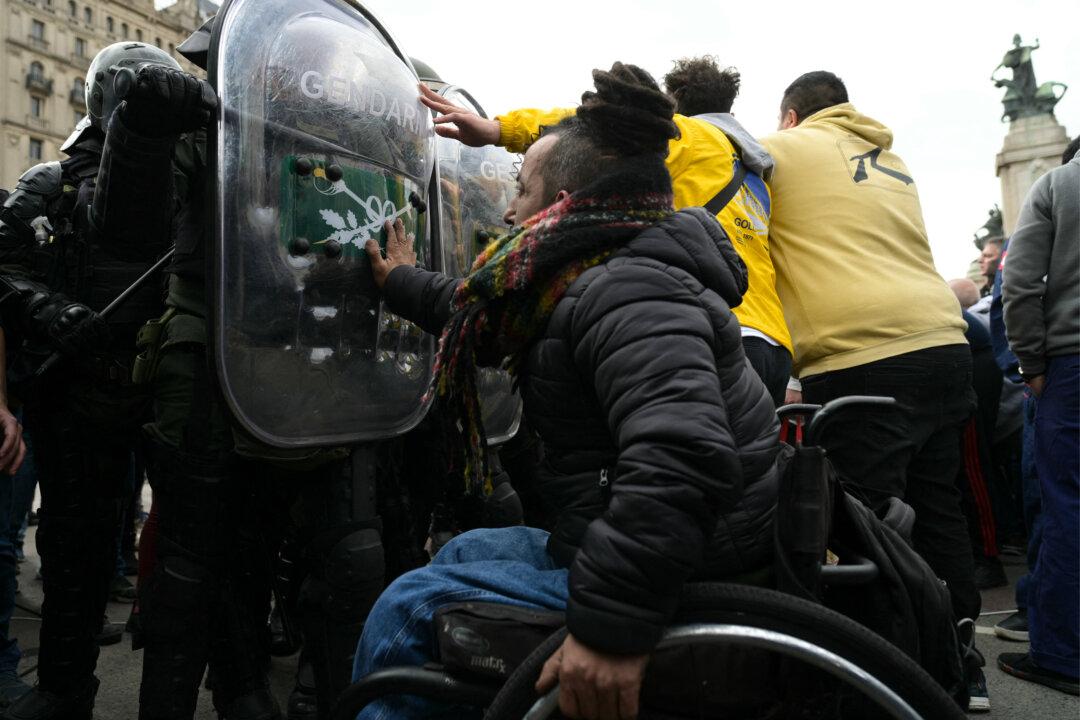 People with disabilities, their families, and health care workers confront riot police during a protest against Argentine President Javier Milei's veto of a law that would have increased retirement and disability pensions outside Congress in Buenos Aires, Argentina, on Aug. 5, 2025. (Atif Aryan/AFP via Getty Images)