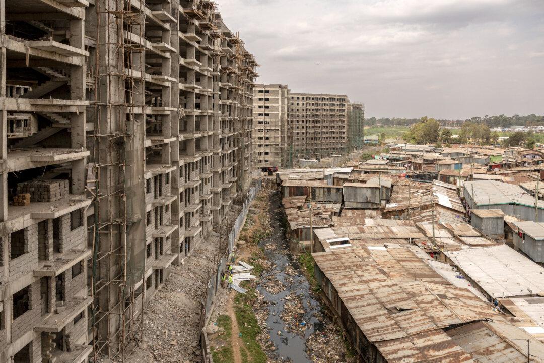 Old residential structures stand next to apartment blocks under construction, at an affordable housing site at the Soweto-B in Kibera, Nairobi, on Aug. 5, 2025. (Simon Maina/AFP via Getty Images)