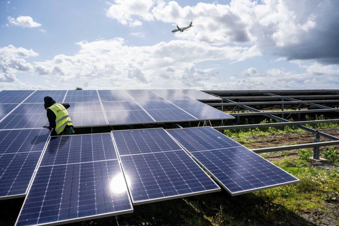 A worker removes panels of a solar farm near Schiphol Airport, in Zwanenburg, Netherlands, on Aug. 5, 2025, after the reflected sunlight blinded pilots. (Simon Lenskens/ANP/AFP via Getty Images)