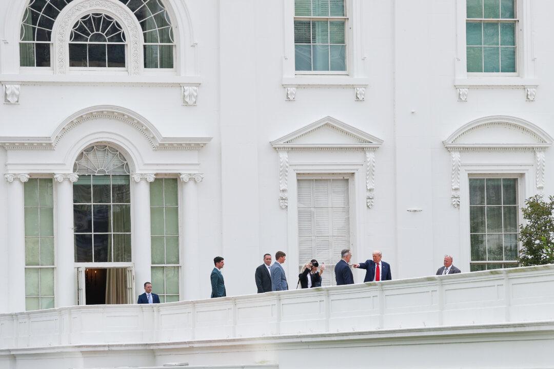President Donald Trump tours the roof of the West Wing of the White House in Washington, on Aug. 5, 2025. Trump has undertaken several renovation projects at the White House, including the construction of a concrete patio at the Rose Garden. (Win McNamee/Getty Images)