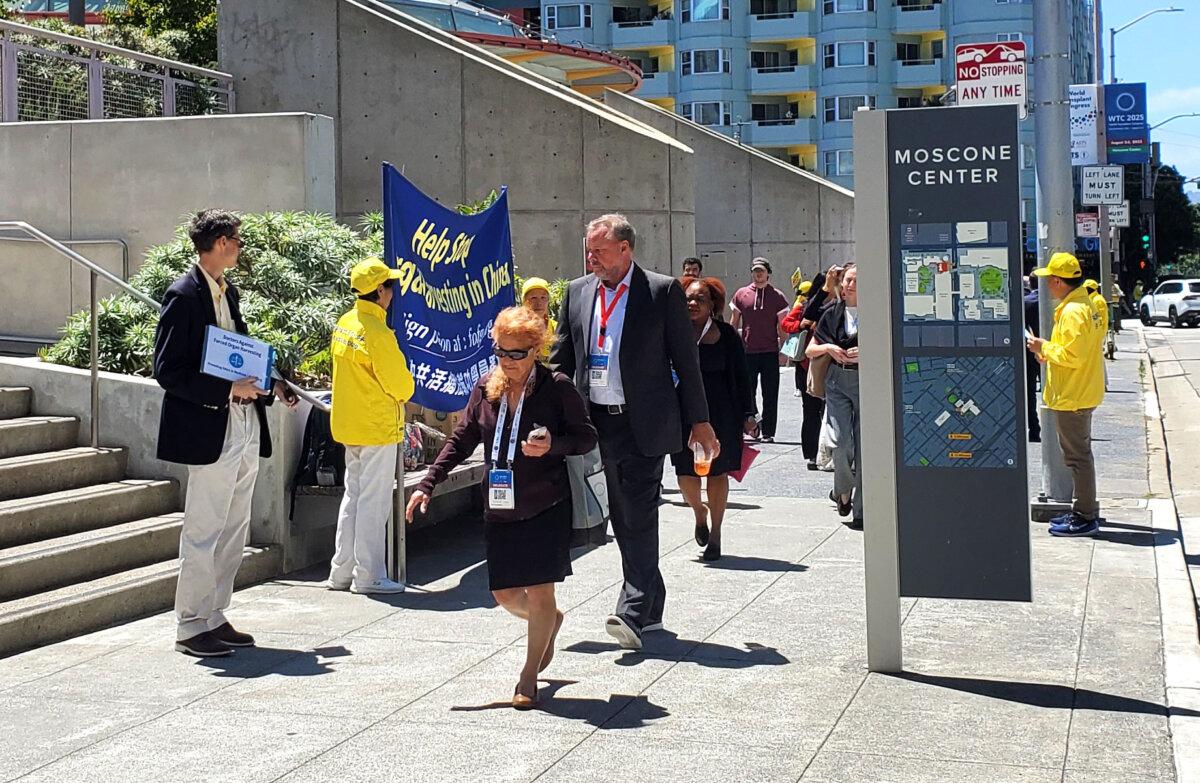 Ali Centurion (L) stays outside the WTC conference reaching out to attendees on Aug. 4. (Gary Wang/The Epoch Times)