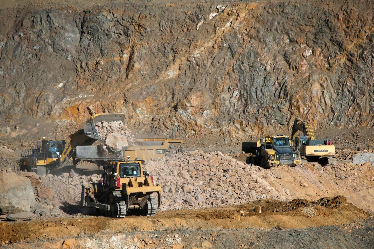Wheel loaders fill trucks with ore at the MP Materials rare earth mine in Mountain Pass, Calif., on Jan. 30, 2020. (Steve Marcus/Reuters)