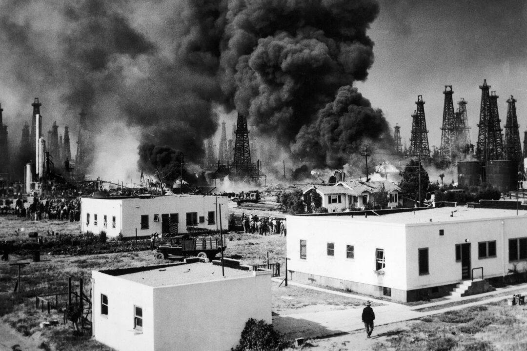An explosion and resultant fire on the Signal Hill Oil Field threatens nearby homes, in Long Beach, Calif., in June 1933. (FPG/Hulton Archive/Getty Images)