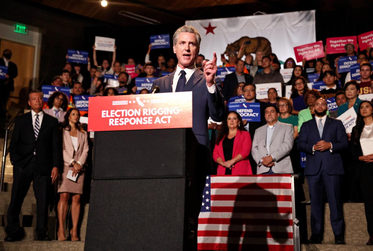 California Gov. Gavin Newsom (C) speaks about the Election Rigging Response Act as Sen. Alex Padilla (D-Calif.) (L) looks on at a news conference at the Democracy Center at the Japanese American National Museum in Los Angeles on Aug. 14, 2025. (Mario Tama/Getty Images)