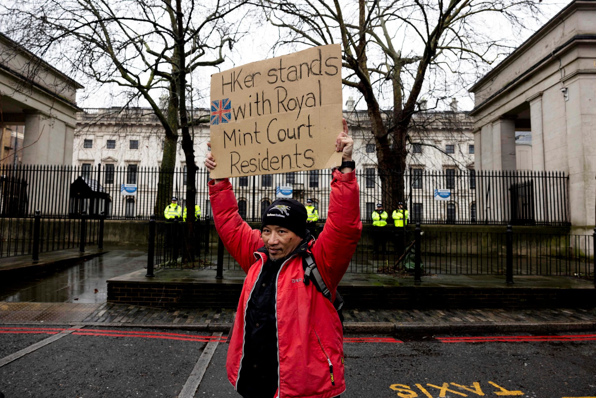 A protester holds a placard during a demonstration against the proposed site of the new Chinese Embassy, outside Royal Mint Court, in London, on Feb. 8, 2025. (Carlos Jasso/Reuters)