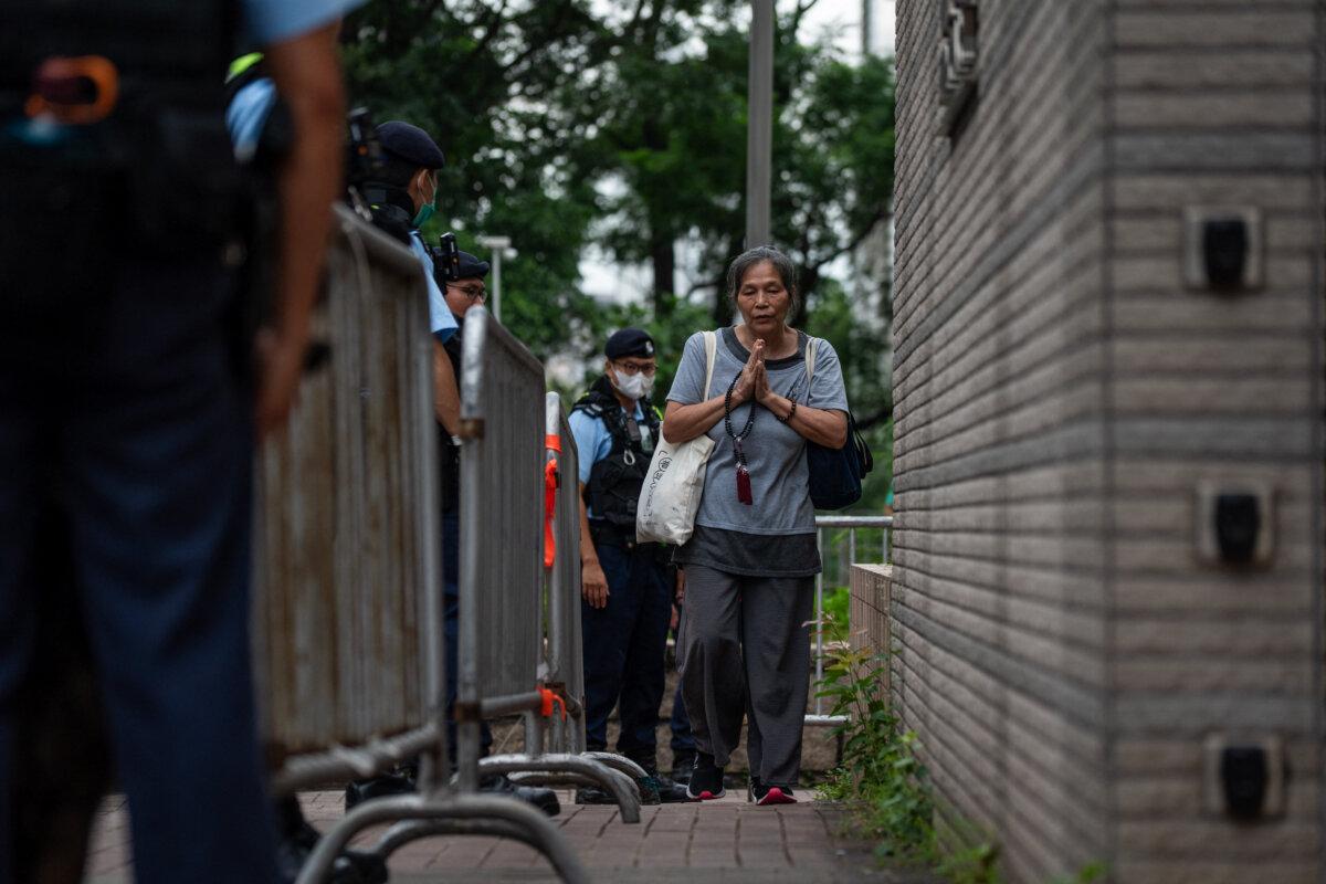 People arrive at the West Kowloon court for jailed Hong Kong media mogul Jimmy Lai's national security trial in Hong Kong on Aug. 28, 2025. (Vernon Yuen/AFP via Getty Images)