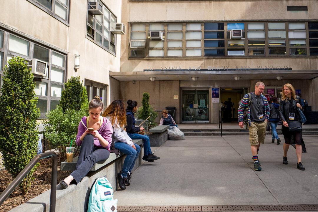 People and students mill about on the campus of Hunter College of The City University of New York in New York City on April 10, 2017. Following a state budget approval, New York became the first state to make public colleges and universities free for qualified middle-class students with a family income under $125,000. (Drew Angerer/Getty Images)