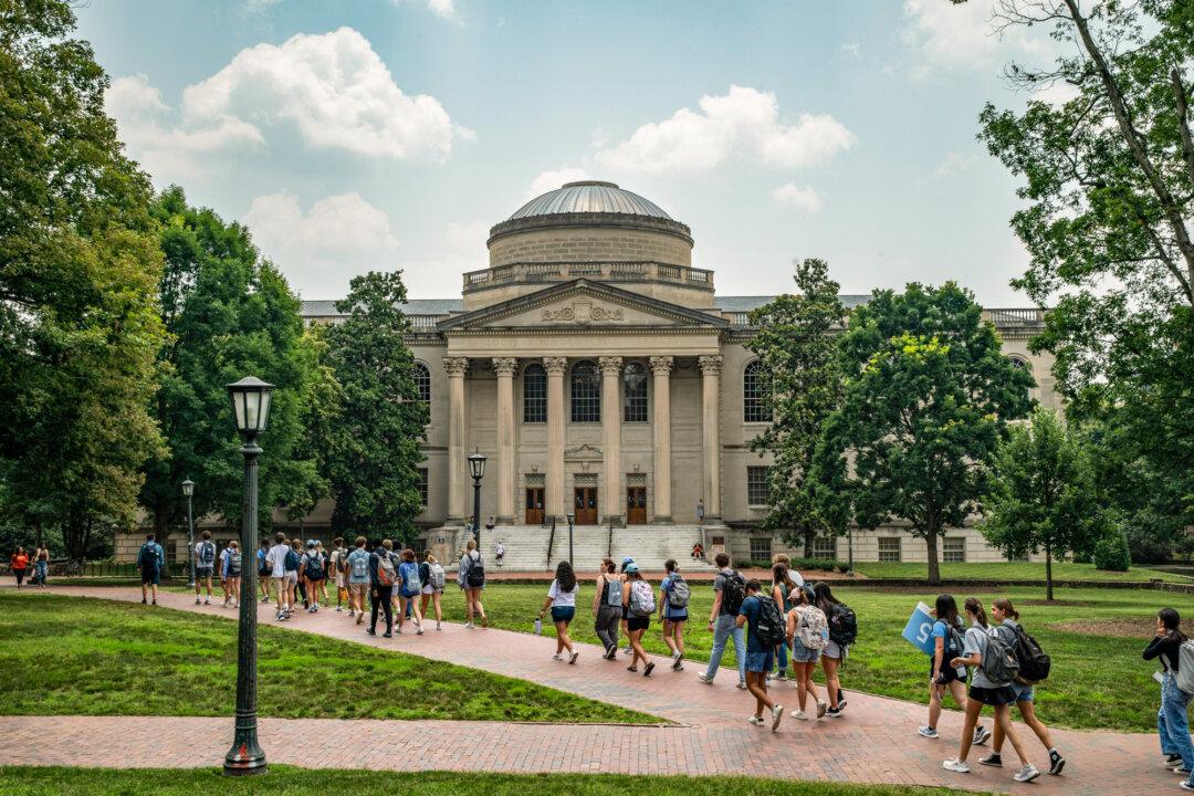 People walk on the campus of the University of North Carolina–Chapel Hill in Chapel Hill, N.C., on June 29, 2023. At the state’s flagship school, the cap for out-of-state students, which includes other U.S. citizens, illegal immigrants, and international students, is 18 percent. (Eros Hoagland/Getty Images)