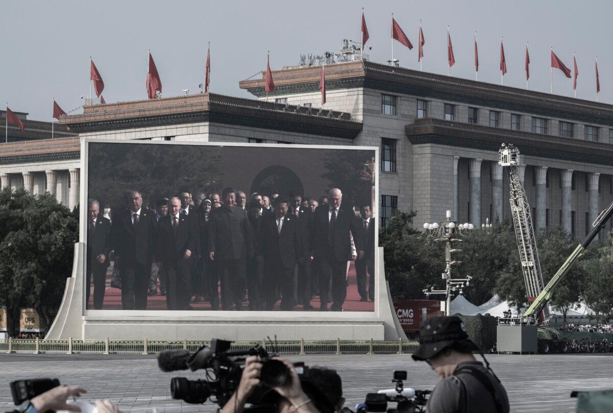 A large screen shows Chinese leader Xi Jinping (C), Russian President Vladimir Putin (3rd L), North Korean leader Kim Jung Un (2nd R), and others arriving at a military parade marking the 80th anniversary of victory over Japan and the end of World War II, in Tiananmen Square in Beijing on Sept. 3, 2025. (Kevin Frayer/Getty Images)