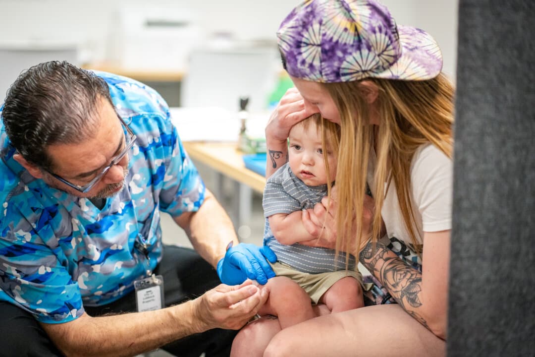 A one year-old is held by his mother while he receives an MMR vaccine at a clinic in Lubbock, Texas, on March 1, 2025. (Jan Sonnenmair/Getty Images)