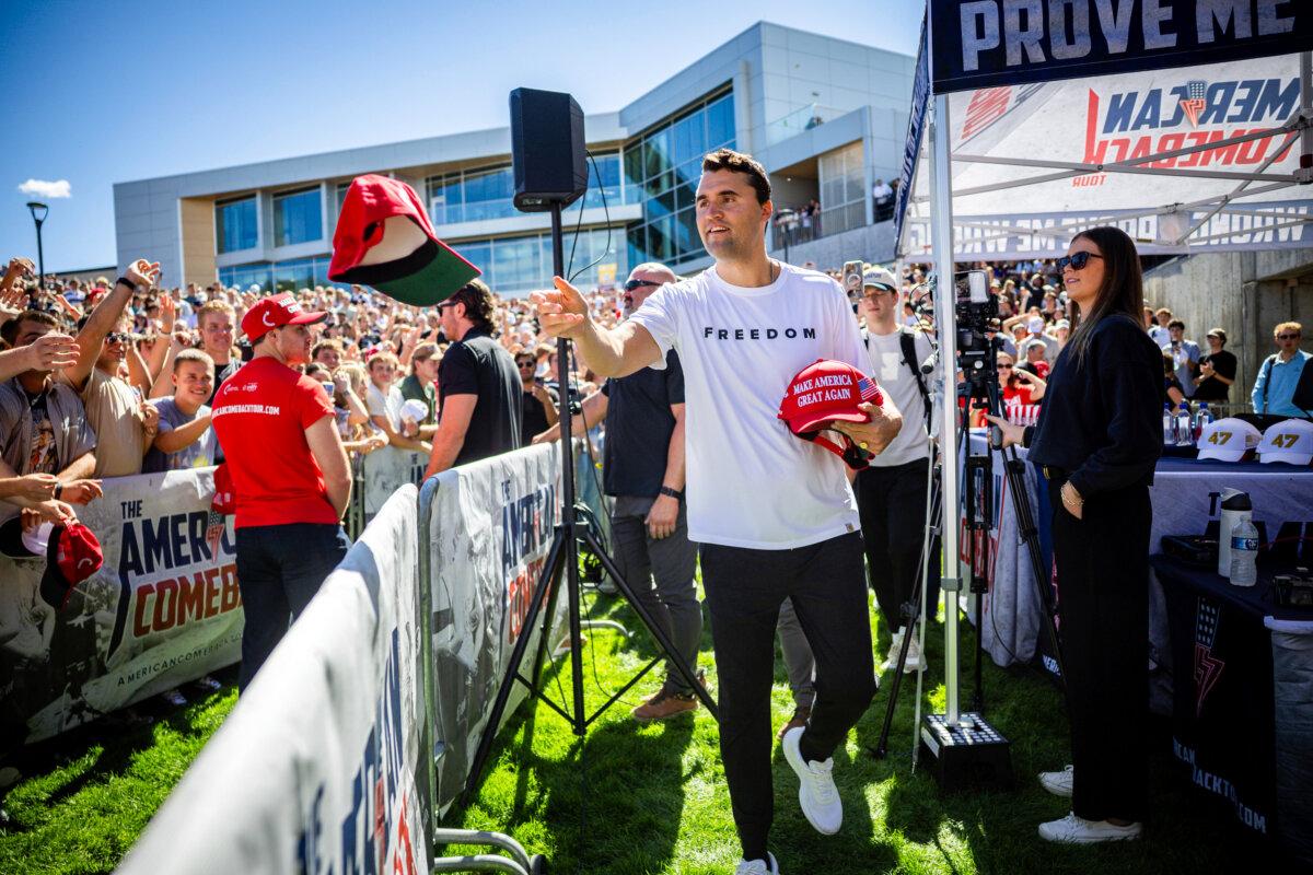 Charlie Kirk hands out hats before speaking at Utah Valley University in Orem, Utah, on Sept. 10, 2025. (Tess Crowley/The Deseret News via AP)