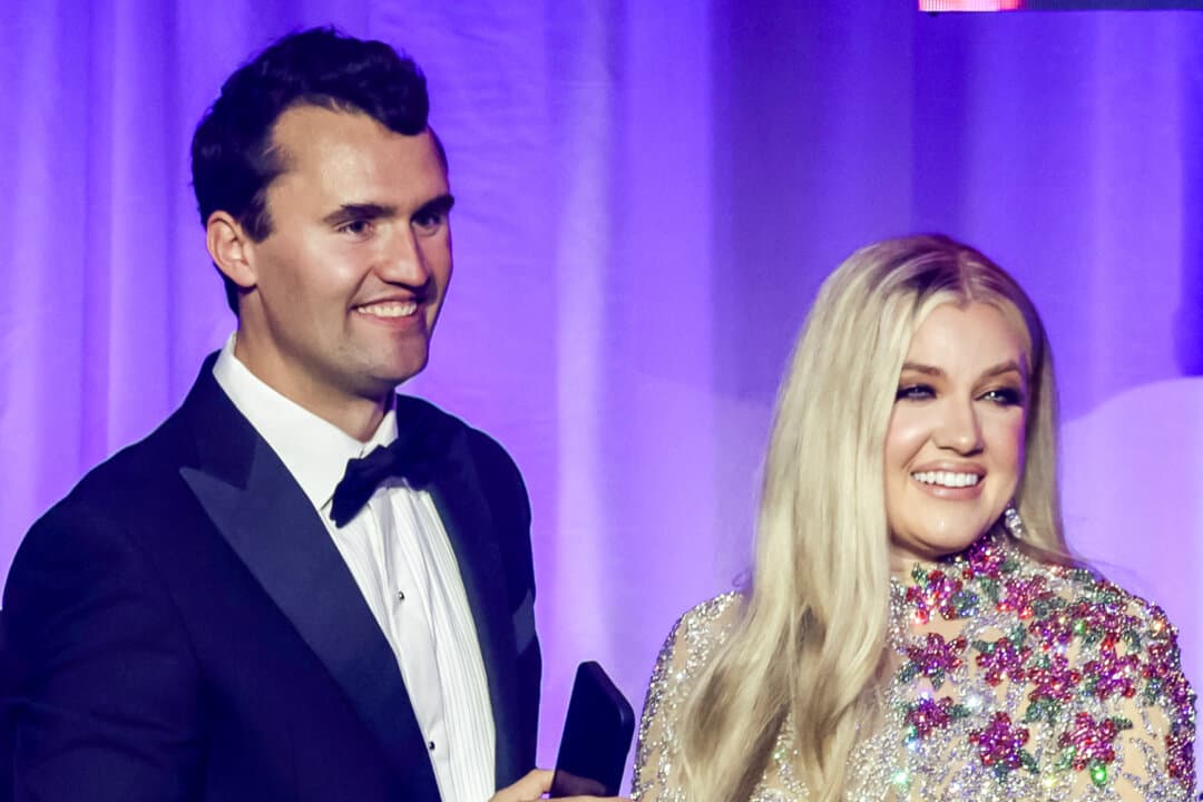 Charlie Kirk and and his wife, Erika Lane Frantzve, watch as Village People performs on stage during the Turning Point USA Inaugural-Eve Ball at the Salamander Hotel in Washington on Jan. 19, 2025. (Samuel Corum/Getty Images)