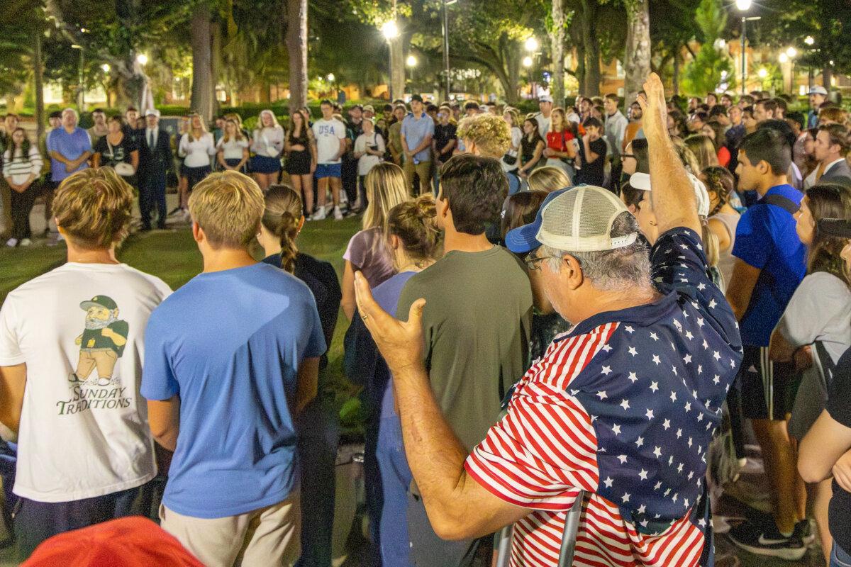 Students and other supporters holding a vigil to honor the memory of Charlie Kirk sing "Amazing Grace" at the University of Florida in Gainesville, on Sept. 11, 2025. (Courtesy of Natasha Holt)