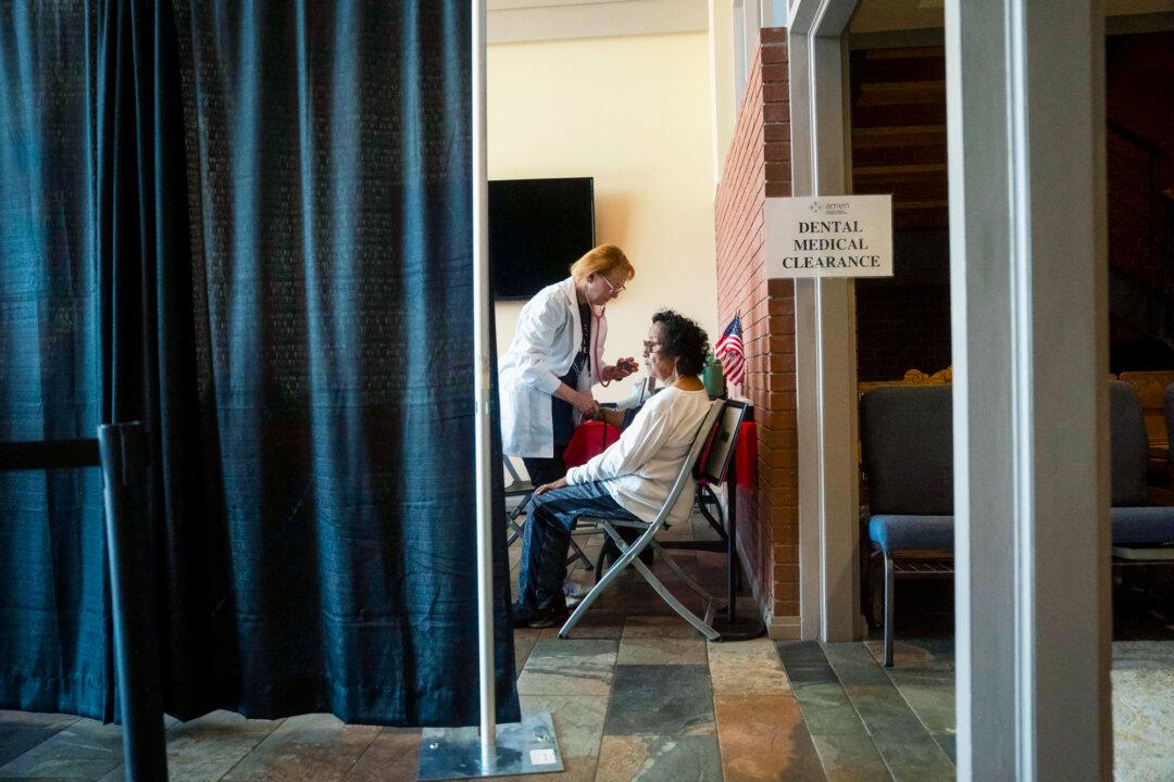 A patient receives care at a health clinic in Asheville, N.C., on June 27, 2025. Critics say the Affordable Care Act’s one-size-fits-all rules led young, healthy people to pay more, prompting them to leave the market and driving premiums higher. (Allison Joyce/AFP via Getty Images)