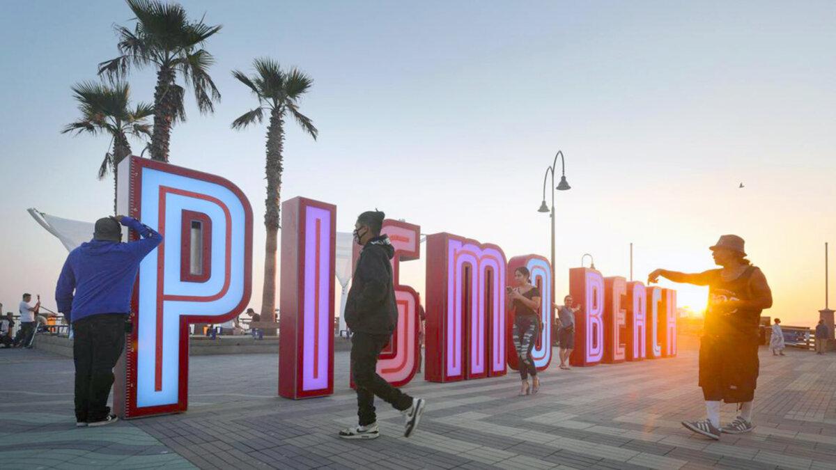 Pismo Beach unveiled a massive new neon sign that was instantly a destination for selfies, as well as other improvements to its Pier Plaza. (David Middlecamp/The San Luis Obsipo Tribune/TNS)