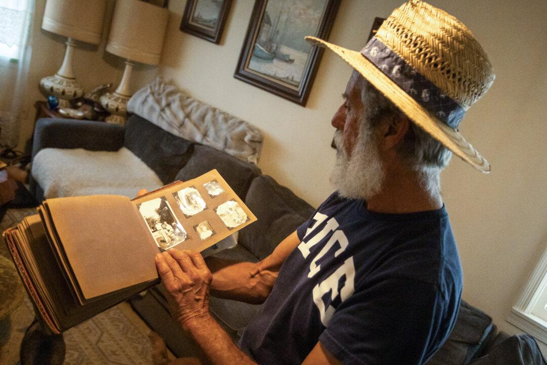 Organic rice farmer Bruce Lopes reviews old photographs in Willows, Calif., on Sept. 4, 2025. (John Freddicks/The Epoch Times)