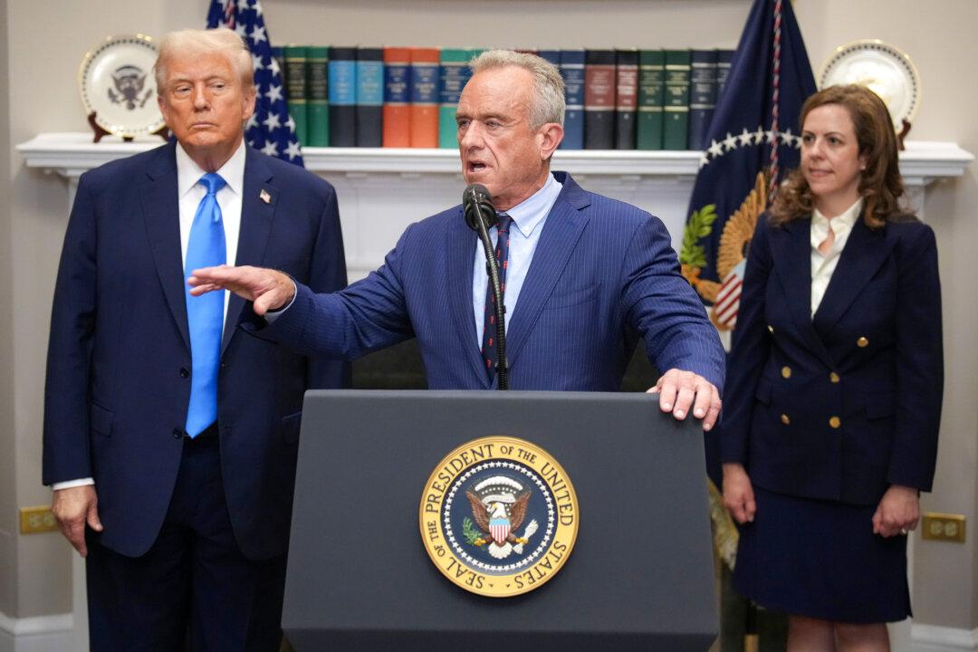 President Donald Trump (L) and acting Assistant Secretary for Health Dr. Dorothy Fink (R) look on as Health Secretary Robert F. Kennedy Jr. (C) speaks at the White House on Sept. 22, 2025. Kennedy announced that acetaminophen, the active ingredient in Tylenol, may be associated with autism. (Andrew Harnik/Getty Images)