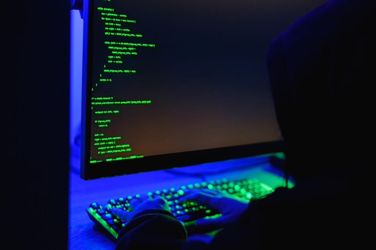 In this photo illustration, hacker types on a computer keyboard on May 13, 2025. (Oleksii Pydsosonnii/The Epoch Times)