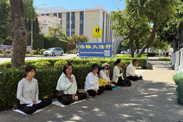 Liu Chuanyu (L) and other Falun Gong practitioners demonstrate in front of a banner outside the Chinese Consulate in Los Angeles on Sept. 4, 2025. (Courtesy of Liu Chuanyu)