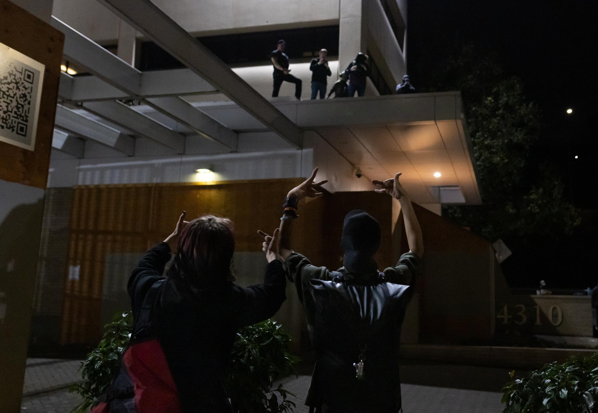 Protesters taunt federal agents in front of Immigration and Customs Enforcement offices in Portland, Ore., on Oct. 3, 2025. (John Fredricks/The Epoch Times)