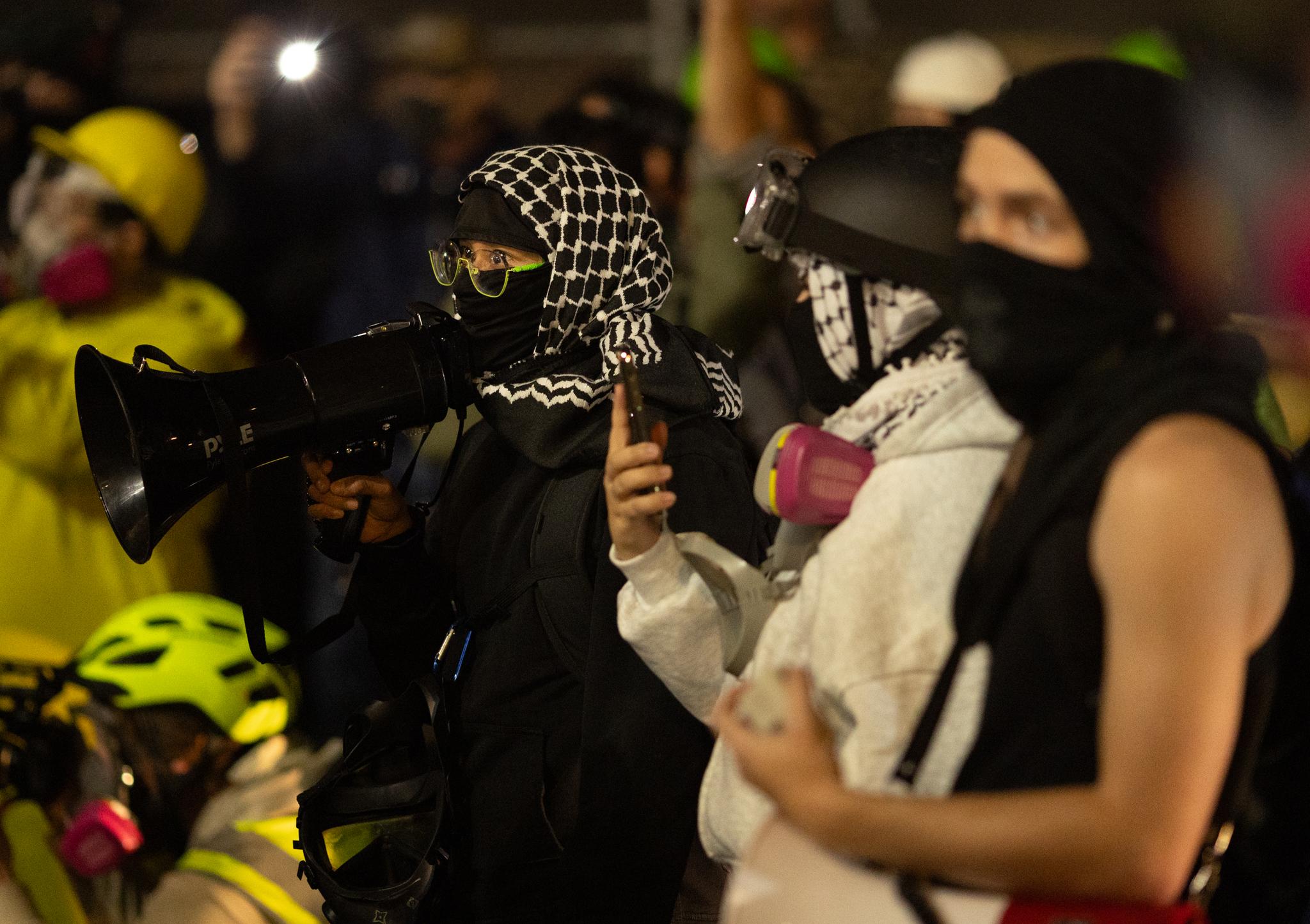 Protesters in a stand-off with federal agents at Immigration and Customs Enforcement offices in Portland, Ore., on Oct. 3, 2025. (John Fredricks/The Epoch Times)