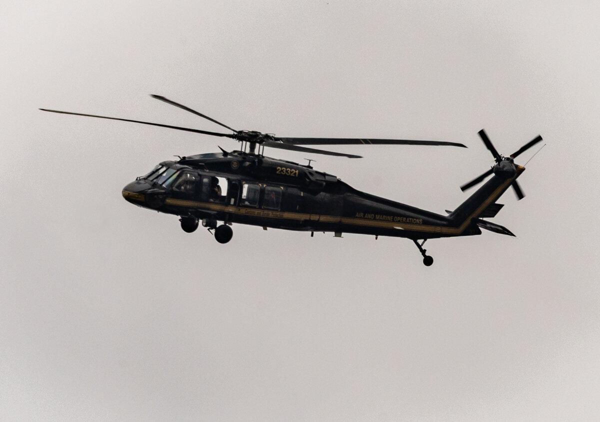 Federal agents monitor crowds of protesters at Immigration and Customs Enforcement offices in Portland, Ore., on Oct. 4, 2025. (John Fredricks/The Epoch Times)
