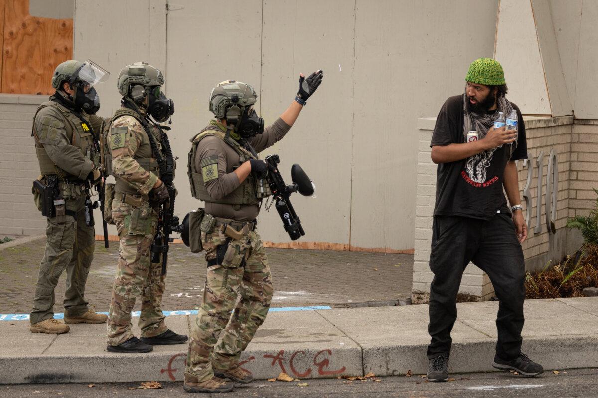 Federal agents move a protester away from the front of Immigration and Customs Enforcement offices in Portland, Ore., on Oct. 4, 2025. (John Fredricks/The Epoch Times)