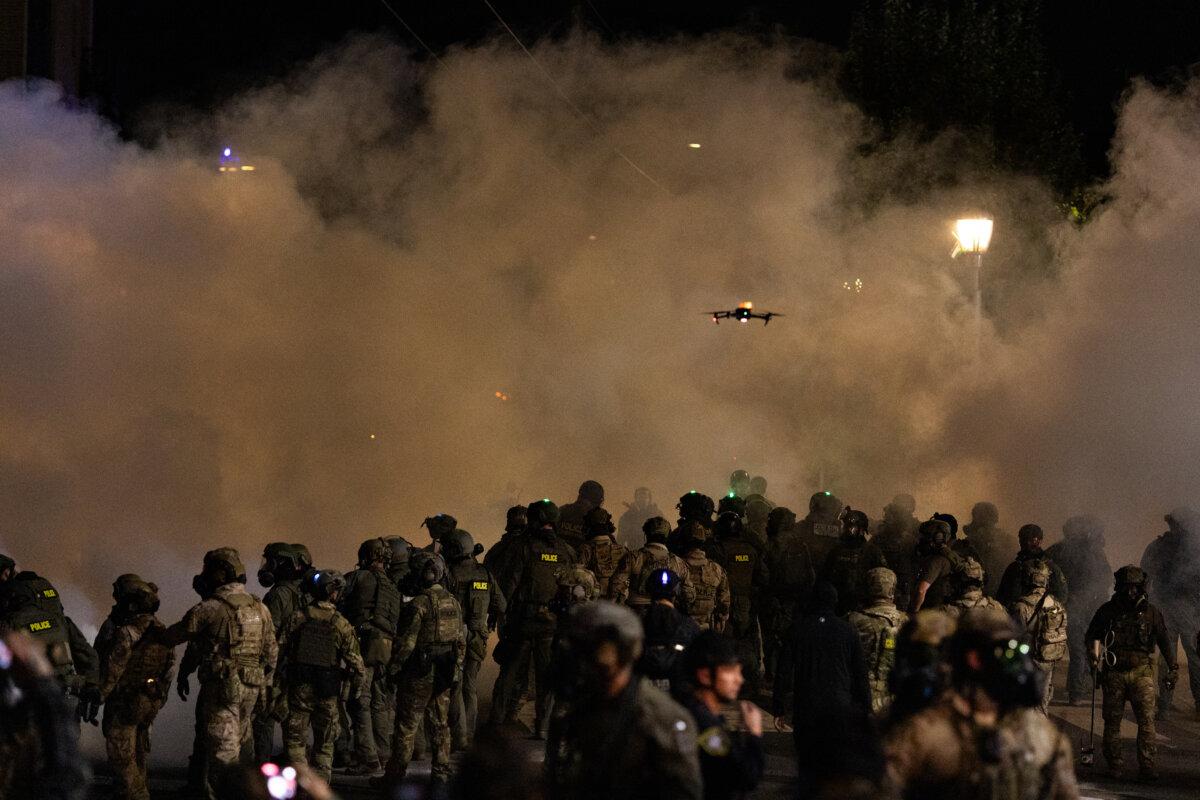 Protesters grow in numbers at the front of Immigration and Customs Enforcement offices in Portland, Ore., on Oct. 4, 2025. (John Fredricks/The Epoch Times)
