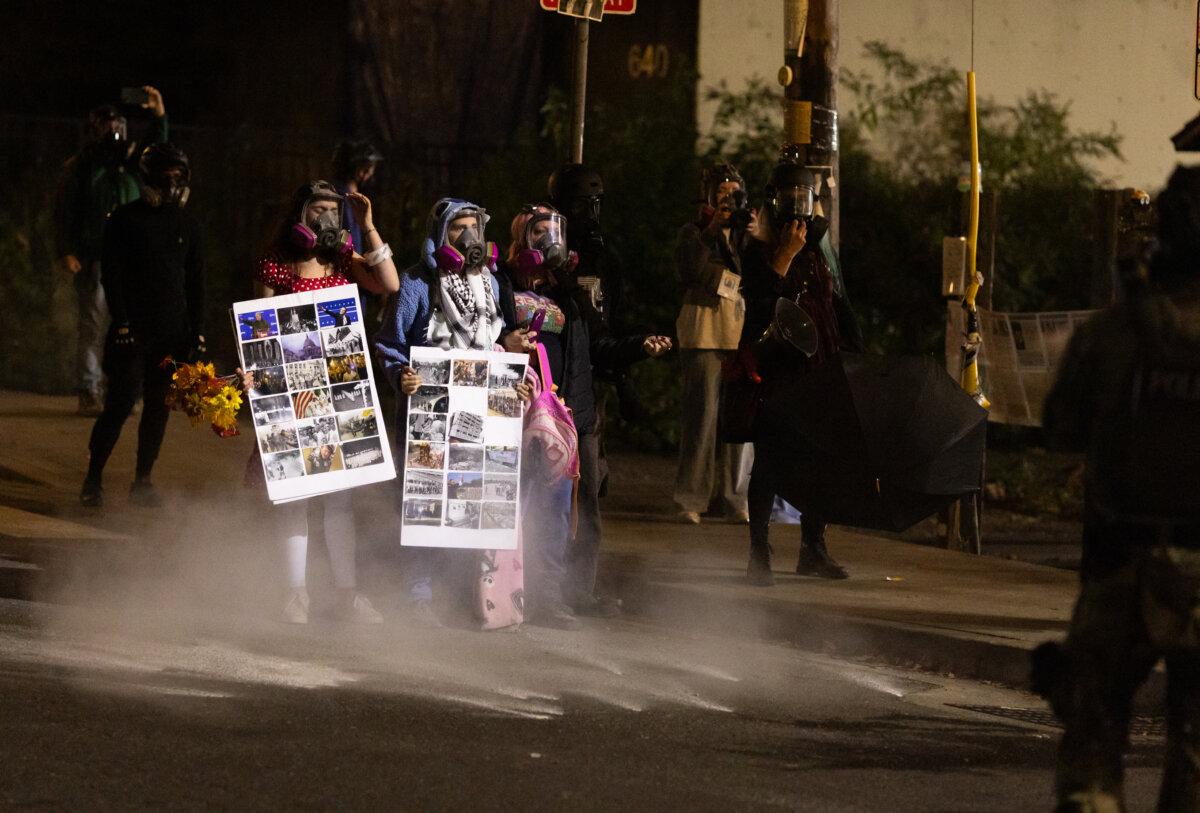 Pepper ball rounds land near protesters in front of Immigration and Customs Enforcement offices in Portland, Ore., on Oct. 4, 2025. (John Fredricks/The Epoch Times)