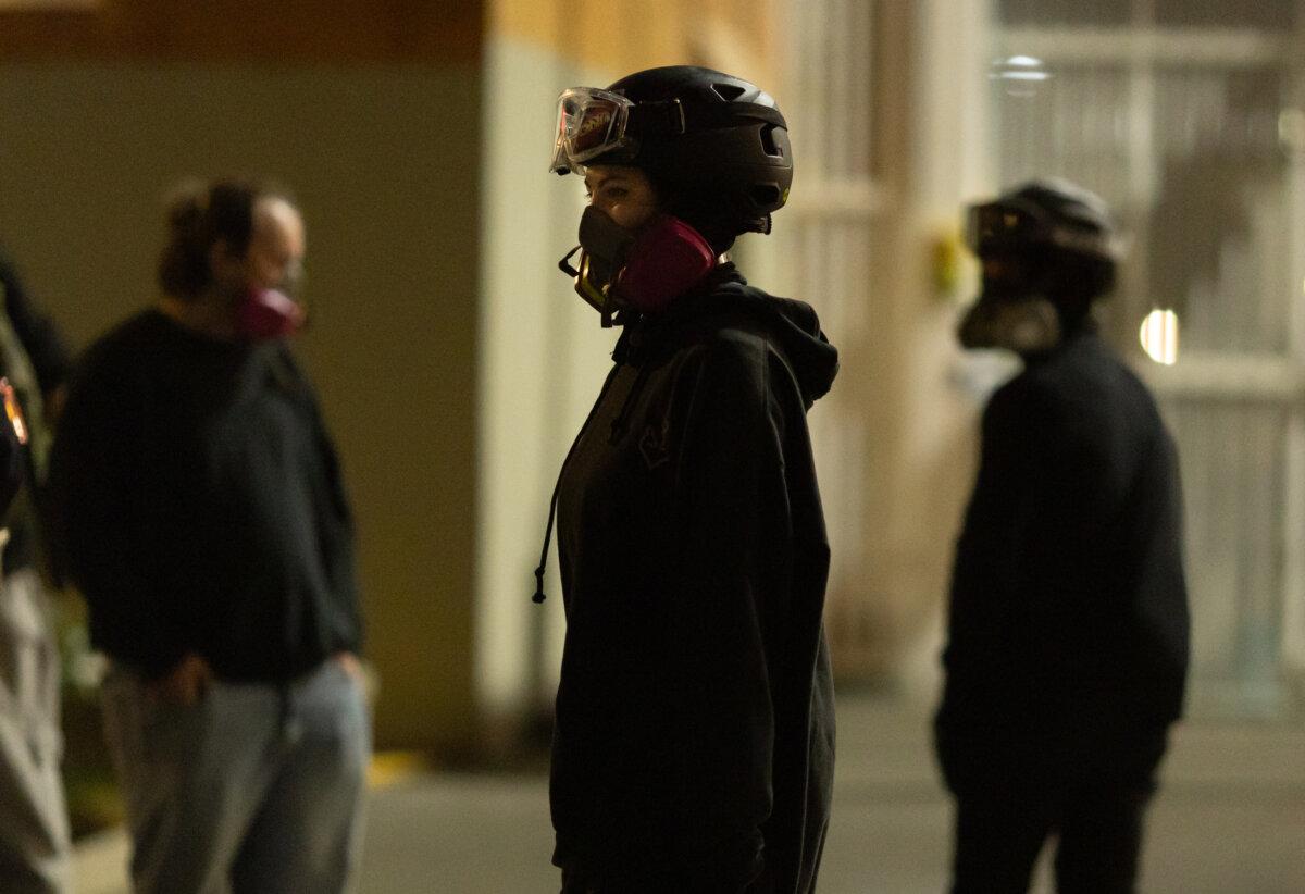 Protesters stand in front of Immigration and Customs Enforcement offices in Portland, Ore., on Oct. 5, 2025. (John Fredricks/The Epoch Times)