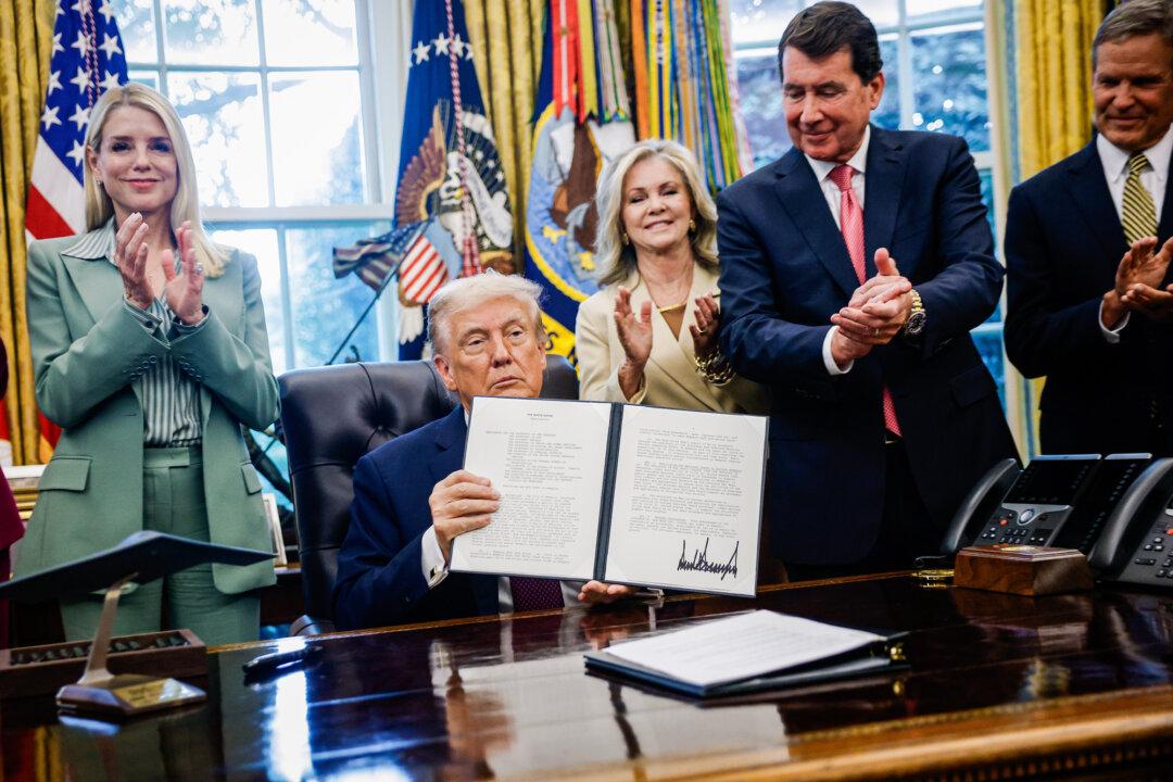 President Donald Trump holds up a signed presidential memorandum that directs members of the National Guard and federal law enforcement agencies to Memphis in an effort to decrease crime in the city, in the Oval Office on Sept. 15, 2025. (Kevin Dietsch/Getty Images)