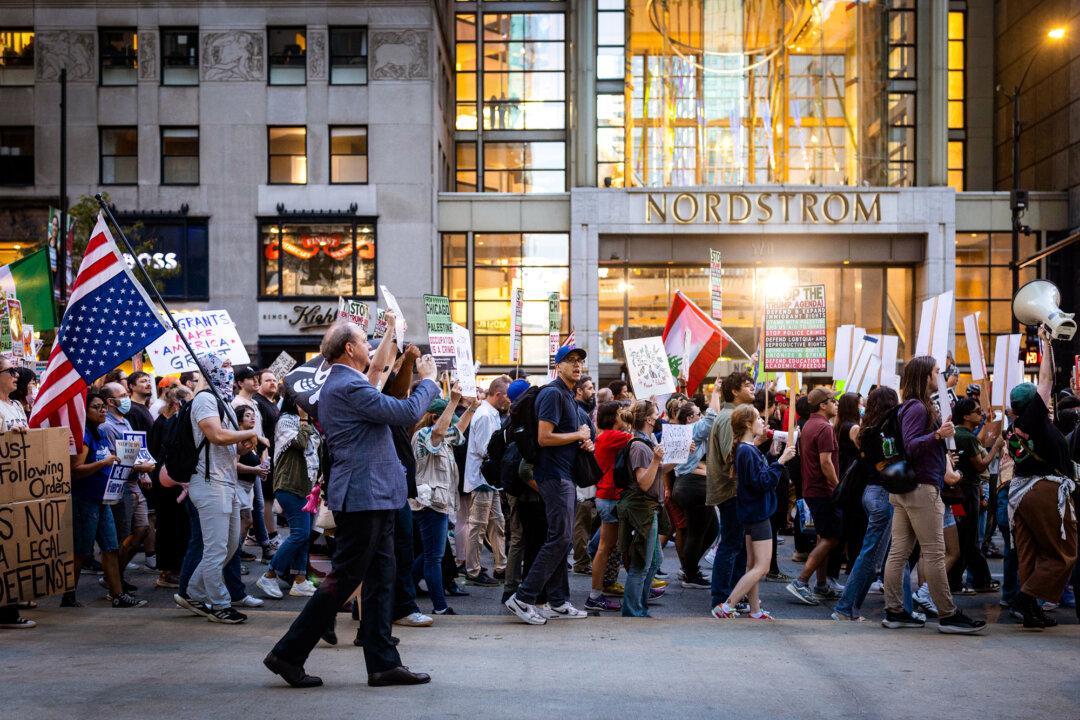 Demonstrators march along the Magnificent Mile to protest against federal immigration operations carried out by Immigration and Customs Enforcement in Chicago on Sept. 30, 2025. (Scott Olson/Getty Images)