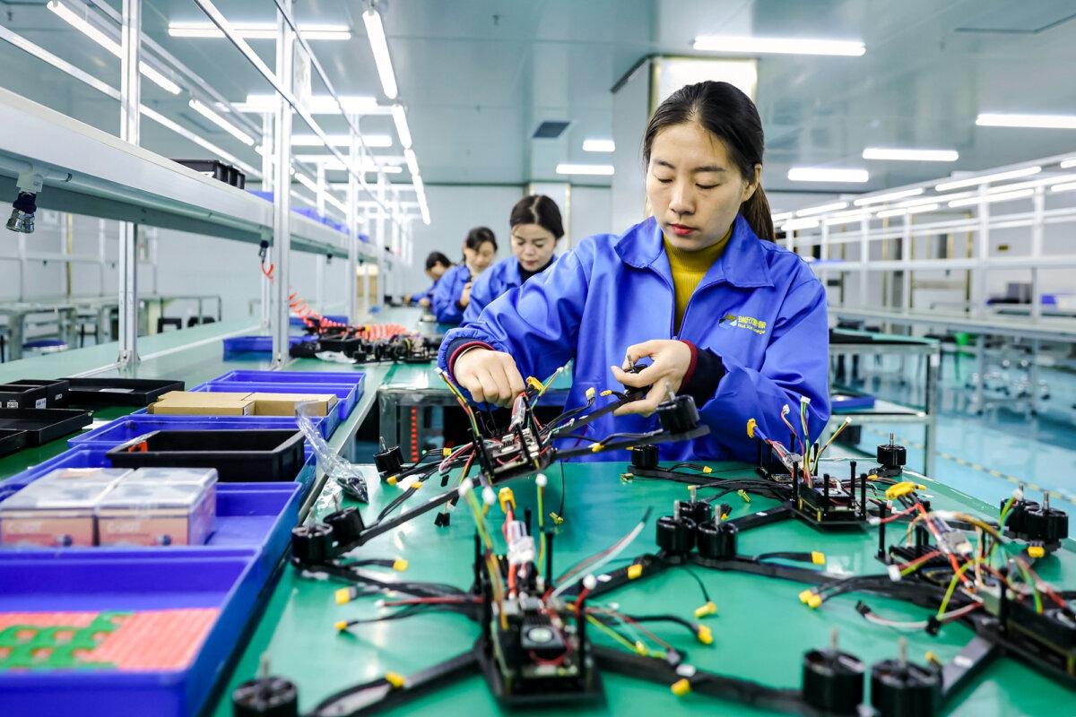Employees work on a production line of drones intended for export at a factory in Ruichang, Jiangxi Province, China, on Nov. 27, 2024. (STR/AFP via Getty Images)