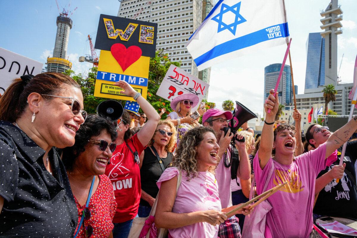 People celebrate following the announcement of a Gaza cease-fire deal, at Hostage Square in Tel Aviv on Oct. 9, 2025. (Maya Levin/AFP via Getty Images)