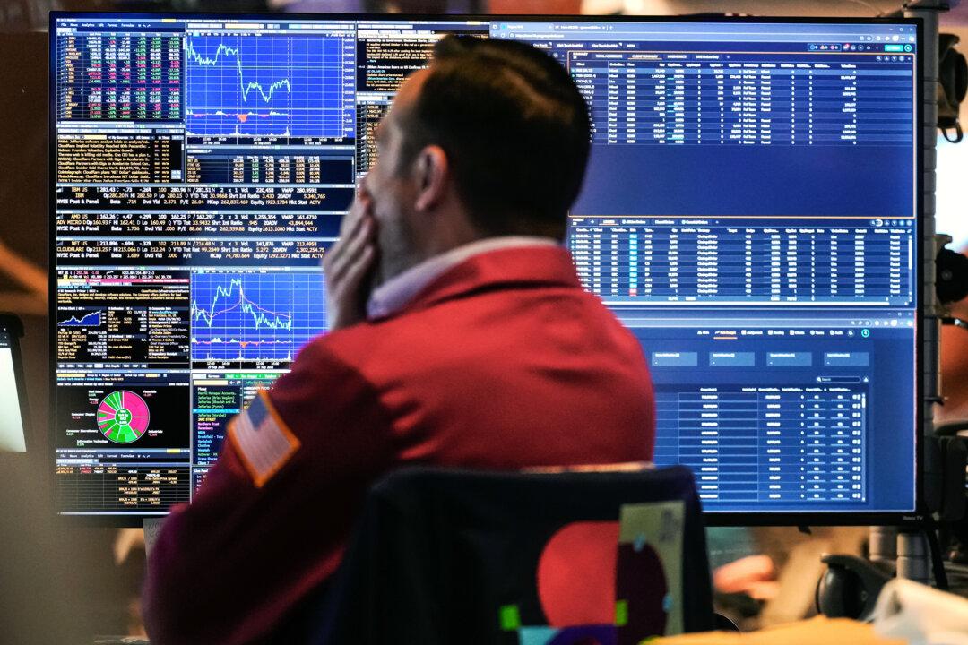 A trader monitors financial data on the floor of the New York Stock Exchange on Oct. 1, 2025. U.S. stocks fell on Oct. 10 over concerns that China’s new rare earth export controls could hurt growth at AI companies. (Seth Wenig/AP Photo)
