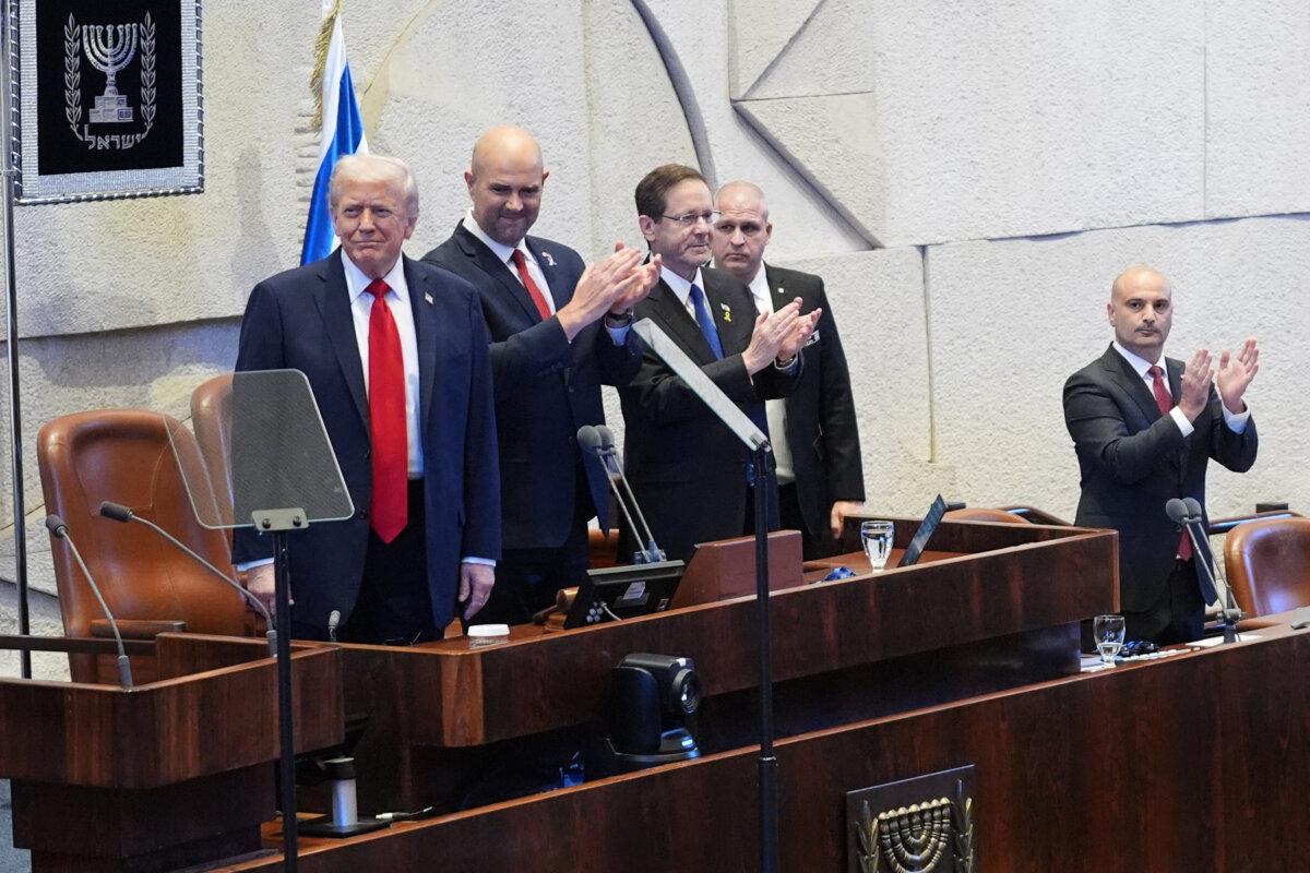 U.S. President Donald Trump arrives with Knesset Speaker Amir Ohana and Israel's President Isaac Herzog to speak to the Knesset, Israel's parliament, in Jerusalem on Oct. 13, 2025. (Evan Vucci - Pool/Getty Images)