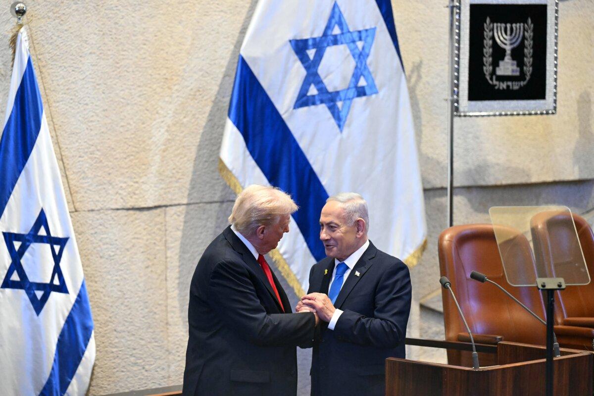 JERUSALEM - OCTOBER 13: U.S. President Donald Trump (L) holds hands and speaks with Israeli Prime Minister Benjamin Netanyahu at the Israeli parliament, the Knesset, on October 13, 2025 in Jerusalem. President Trump is visiting the country hours after Hamas released the remaining Israeli hostages captured on Oct. 7, 2023, part of a US-brokered ceasefire deal to end the war in Gaza. (Photo by Saul Loeb - Pool/Getty Images)