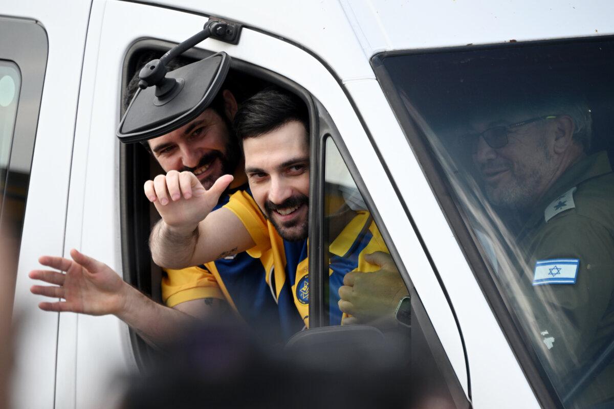 Gaza hostages Ziv and Gali Berman wave to supporters as they are transported in a vehicle after their arrival at Chaim Sheba Medical Center at Tel HaShomer in Ramat Gan, Israel, on Oct. 13, 2025. (Alexi J. Rosenfeld/Getty Images)