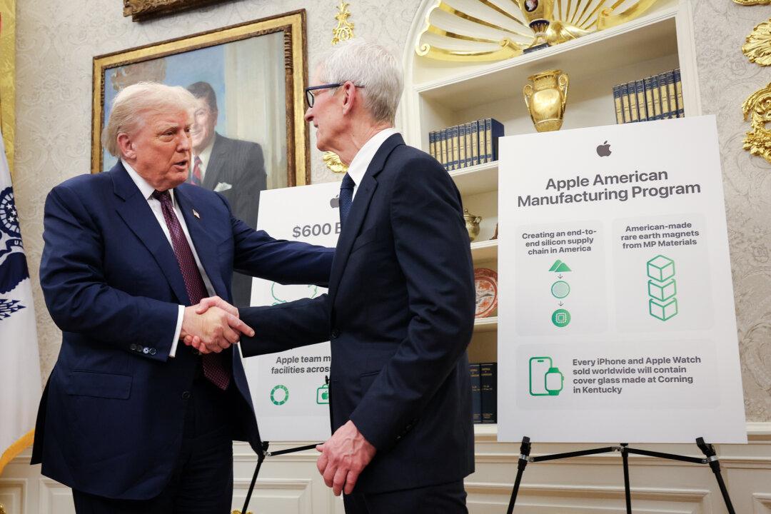 President Donald Trump (L) shakes hands with Apple CEO Tim Cook during an event in the Oval Office on Aug. 6, 2025. Apple Inc. announced a $100 billion investment in manufacturing facilities in the United States, on top of an announcement in February committing over the next four years to a $500 billion investment and the addition of 20,000 new jobs. (Win McNamee/Getty Images)