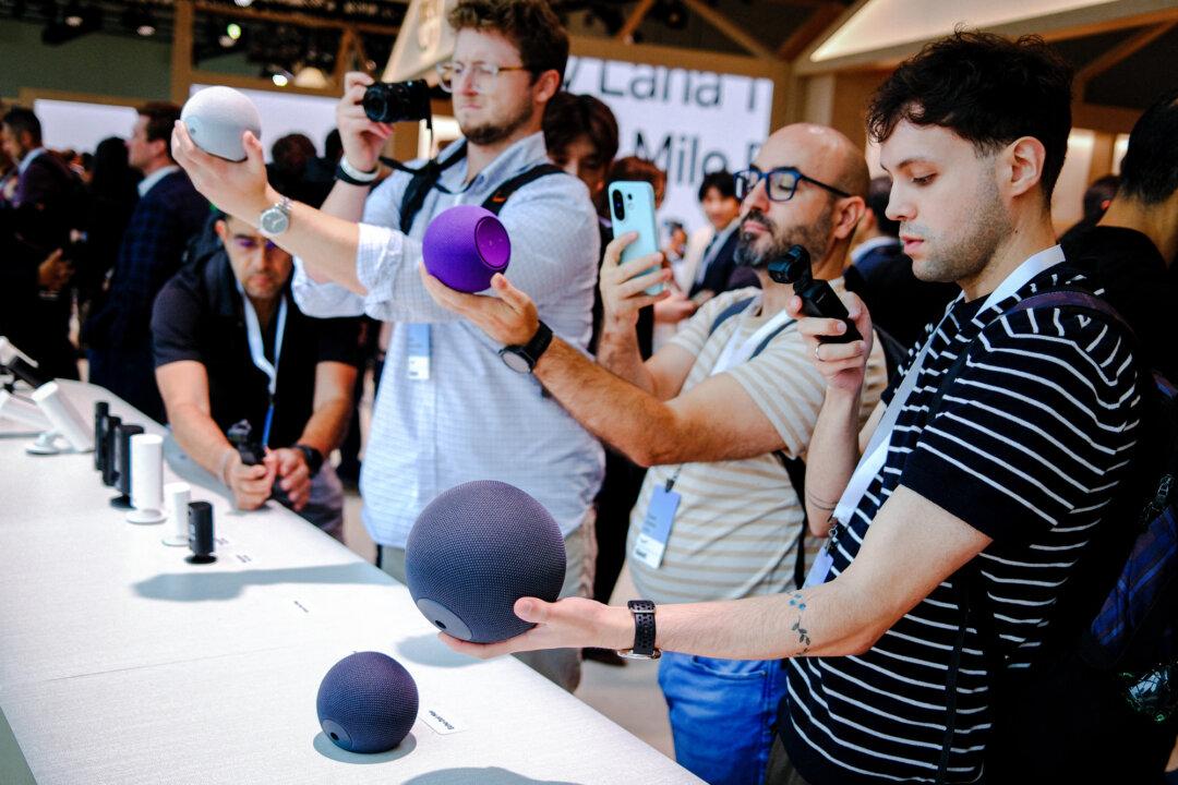 People take pictures of Amazon Echo smart speakers, which are AI-powered, during a product event in New York City on Sept. 30, 2025. (Charly Triballeau/AFP via Getty Images)