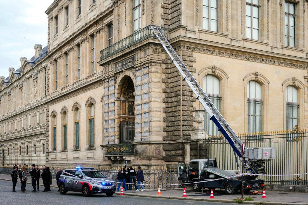 French police officers stand next to an extendable ladder used by the thieves to enter the Louvre museum in Paris on Oct. 19, 2025. (Dimitar Dilkoff/AFP via Getty Images)