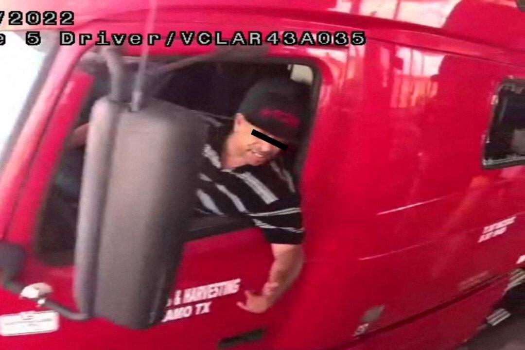 The alleged driver of a truck carrying dozens of illegal immigrants, identified by Mexican immigration officials as “Homero N”, drives through a security checkpoint in this surveillance photograph in Laredo, Texas, on June 29, 2022. (National Institute of Migration/Handout via Reuters)