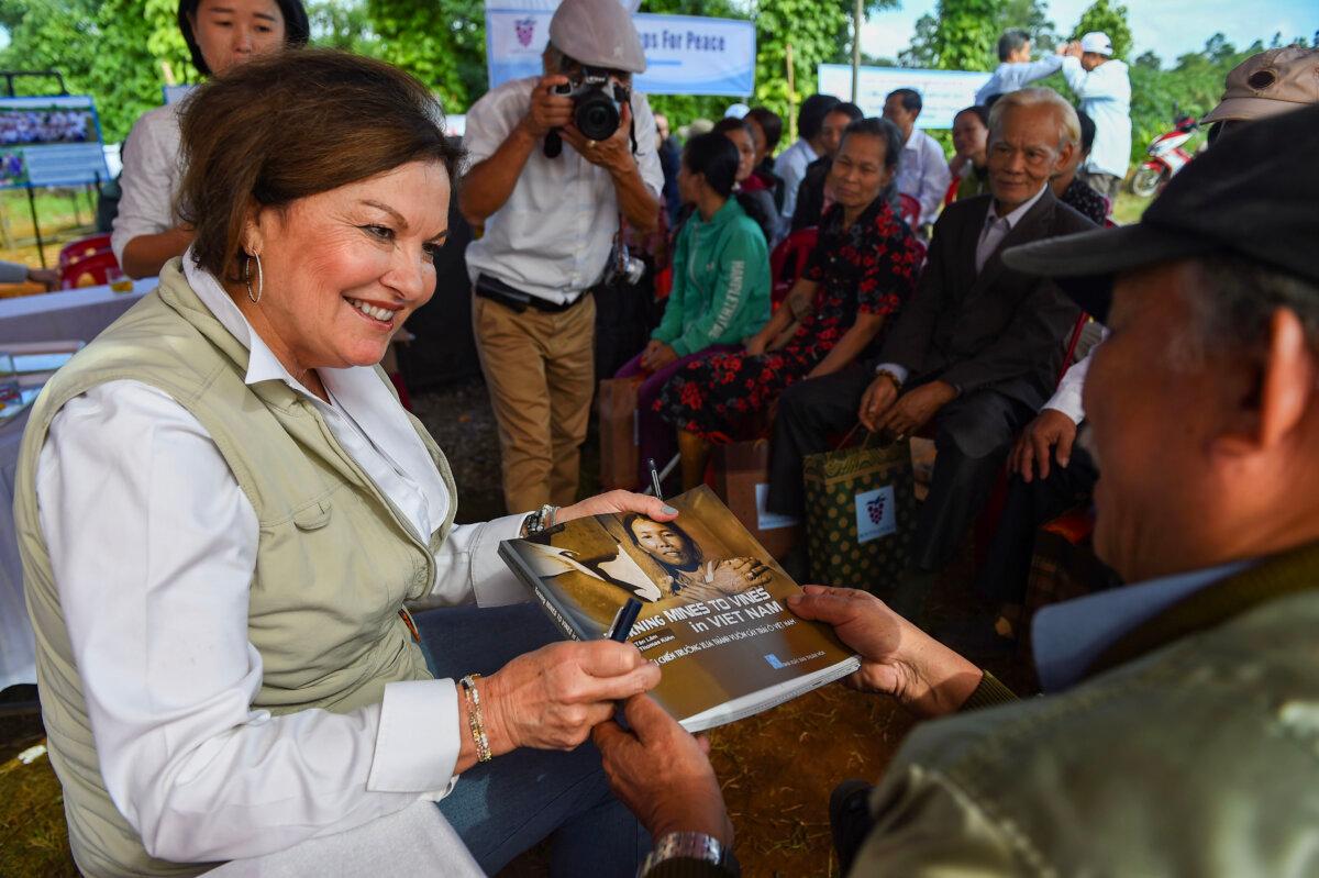 Heidi Kühn, founder of Roots of Peace, presents a book about farmers who became landmine victims on Jan. 6, 2020. (Nhac Nguyen/AFP via Getty Images)