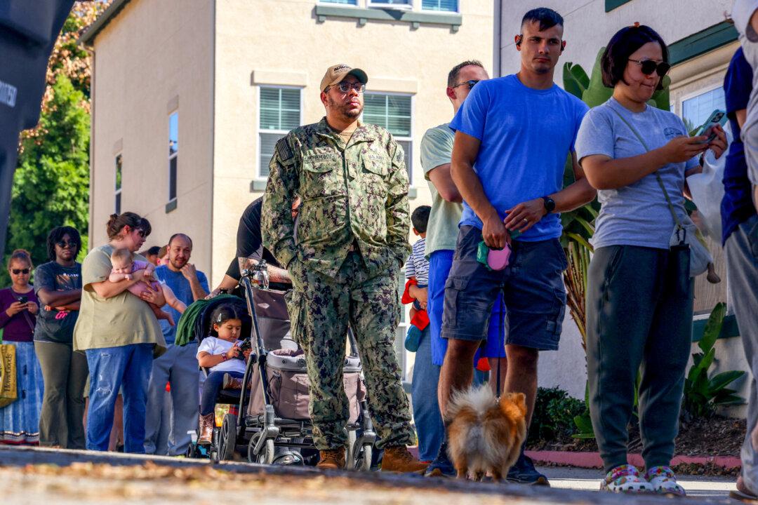 A member of the U.S. Navy stands in line to receive free food from volunteers from the Feeding San Diego food bank in San Diego on Oct. 24, 2025. (Sandy Huffaker/AFP via Getty Images)