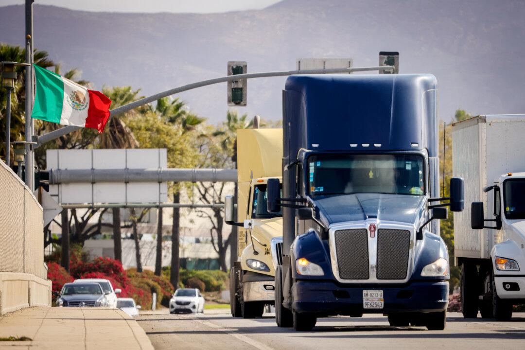 Trucks coming from Mexico enter the United States at an inspection station after crossing the border in Otay Mesa, Calif., on April 1, 2025. The United States posted a $5.1 billion truck trade deficit with Mexico in 2024. (Sandy Huffaker/AFP via Getty Images)