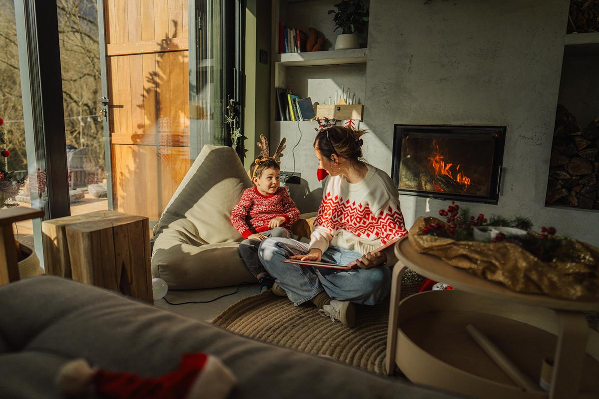 Storytime with children can turn even a hectic December evening into a peaceful, memorable moment. (AleksandarNakic/Getty Images)