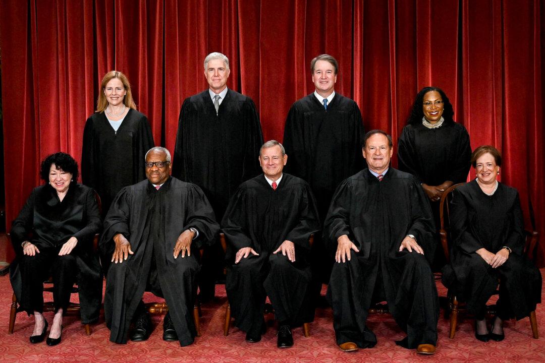 Supreme Court justices pose for an official photo at the court in Washington on Oct. 7, 2022. The court is expected to review several lower-court rulings that deemed Trump’s tariffs unlawful. (Olivier Douliery/AFP via Getty Images)