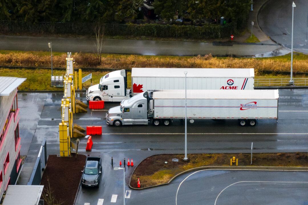 Trucks enter the United States from Canada at the Pacific Highway Port of Entry in Blaine, Wash., on Feb. 1, 2025. Earlier this year, the Trump administration imposed 25 percent tariffs on Mexico and Canada. The Supreme Court will hear arguments on Nov. 5 in a landmark case over the legality of the administration’s global tariffs. (David Ryder/Getty Images)